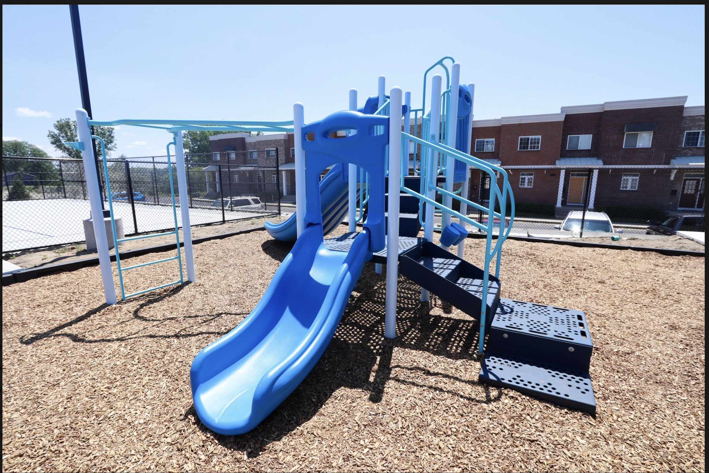 Blue playground slide at Mona Shores Flats